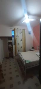 a small room with a bed and a ceiling at Au D LOCATION in Grand-Bourg