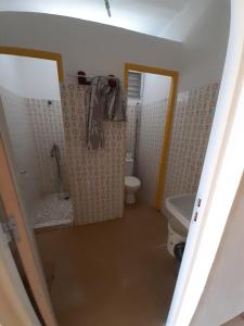 a bathroom with a toilet and a shower and a sink at Au D LOCATION in Grand-Bourg