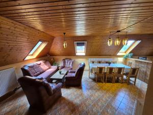 a living room with couches and a table and a kitchen at Berni apartman in Badacsonytomaj