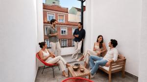 a group of people sitting in chairs on a balcony at Password to Madrid Gran Vía in Madrid