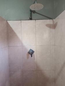 a shower with a shower head in a bathroom at Skaap Kraal Guest Farm in Kakamas +8 photos