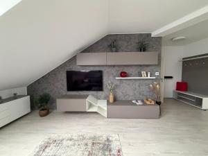 a living room with a tv on a wall at La Brloh Pardubice in Pardubice