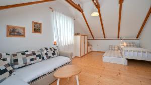 a living room with a couch and a bed at Villa Dobrenic by Villas Guide in Donje Taborište +46 photos