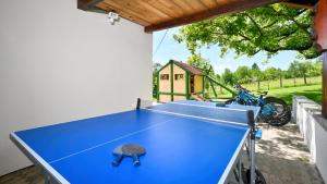 a ping pong table in a backyard with a house at Villa Dobrenic by Villas Guide in Donje Taborište