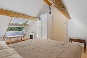 a bedroom with a bed and a window at Gîte Mélany in Chargé