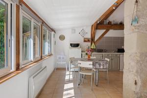 a kitchen and dining room with a table and chairs at Gîte Mélany in Chargé