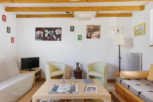 a living room with a couch and a table at Gîte Mélany in Chargé
