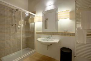 a bathroom with a sink and a shower and a mirror at Windows On Florence in Florence +38 photos