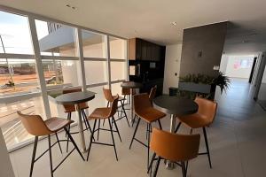 a kitchen with tables and chairs in a room at Westfit Barreto 01 in Mossoró