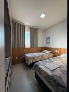 a hotel room with two beds and a television at Westfit Barreto 01 in Mossoró +13 photos