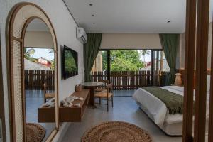 a bedroom with a bed and a mirror at Be Caju Hotel in Barra Grande +57 photos