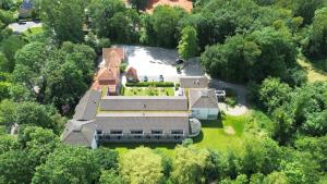 an aerial view of a large house in the woods at Hotel Heemskerk in Heemskerk