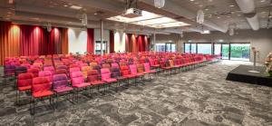 an auditorium with red chairs and red seats at Best Western Malmo Arena Hotel in Malmö
