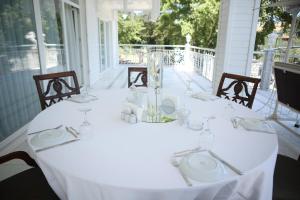 a table with a white table cloth on a porch at Rum Evi By Secret Sense Collection in Safranbolu