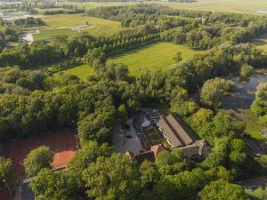 an aerial view of a building in a field and trees at Hotel Heemskerk in Heemskerk