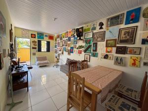 a bedroom with a bed and many pictures on the wall at Casa da Santa Marta in Goiás