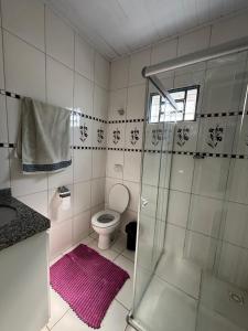 a bathroom with a shower and a toilet at Casa da Santa Marta in Goiás +5 photos
