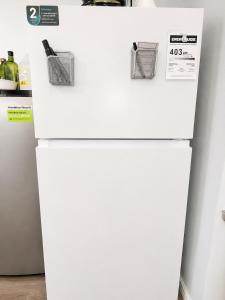 a white refrigerator with two baskets on top of it at Louisbourg room & Aurora House in Glace Bay