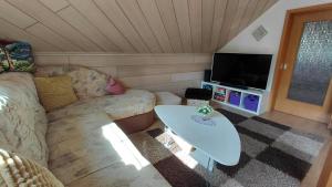 a living room with a couch and a table at Pension & Ferienwohnung Eitler in Aue-Bad Schlema