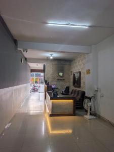 a living room with a couch and a table at Hoysal Grand in Bangalore