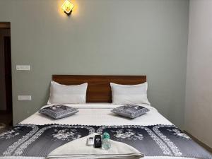 a bed with two pillows on top of it at Hoysal Grand in Bangalore +24 photos