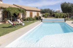 a swimming pool in the backyard of a house at Mas Cairou in Sorède +9 photos