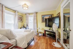 a bedroom with a large bed and a flat screen tv at Room B5 Shared bathroom queen Bed Washer Dryer in Rochester