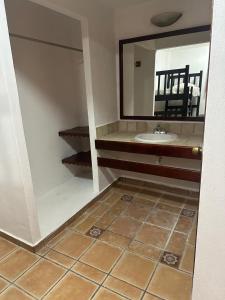 a bathroom with a sink and a mirror at Kaa Zihil Hotel in Playa del Carmen