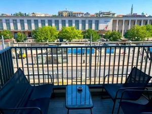 a balcony with chairs and a view of a building at ANMAN HHBB tourism & business rooms in Padova