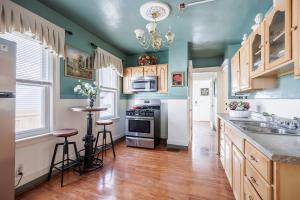 a kitchen with green walls and wooden cabinets and a counter top at Room B5 Shared bathroom queen Bed Washer Dryer in Rochester
