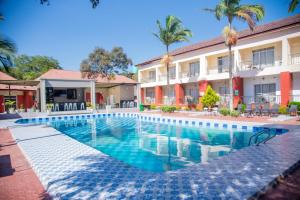 a swimming pool in front of a building at Chamba Valley Exotic Hotel in Lusaka