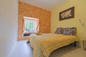 a bedroom with a bed and a window at La Maison Jopateliére in Mohon