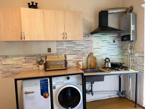 a kitchen with a washing machine on a counter at Nikola apartment ambrolauri in Ambrolauri