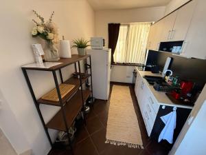 a kitchen with a white refrigerator and a counter at Sweet home see view pool escape in Nesebar
