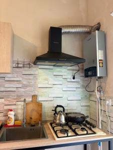 a kitchen with a sink and a stove top oven at Nikola apartment ambrolauri in Ambrolauri +15 photos