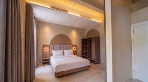 a bedroom with a white bed in a room at St Anne Palace by Tritoni Prestige in Il-Furjana