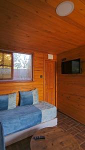 a bedroom with a bed and a television in a room at Ferme Sacrée Nature in Ben Slimane