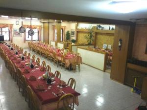 a banquet hall with tables and chairs in a restaurant at Albergo alla Posta B&B in Roana +35 photos