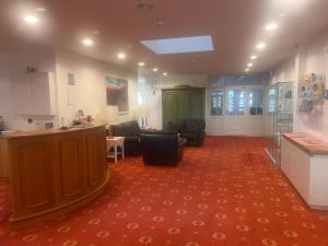 a large living room with a couch and a table at Hotel Seeblick garni in Gartow