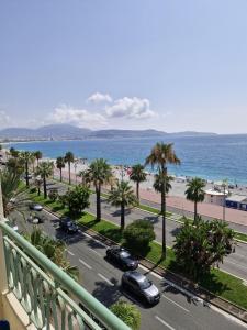 a view of a street with palm trees and the ocean at Azur Pearl - Luxury Sea View Apartement - La plage à vos pieds in Nice
