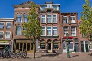 a brick building with bikes parked in front of it at City Hotel Rembrandt in Leiden