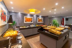 a buffet line with many different types of food at Intercity Salvador in Salvador