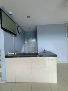a kitchen with a sink and a tv on a wall at Hotel Lean Fatt in Ipoh