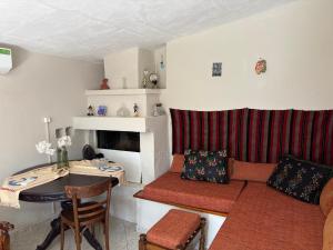 a living room with a couch and a table at Real Holidays Antoniadou - Rustic House in Elaiokhórion +48 photos
