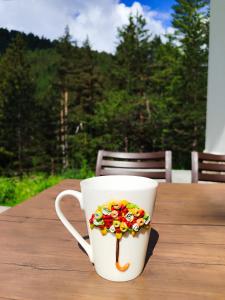 a cup with a cookie on it sitting on a table at Alen Mak in Govedartsi