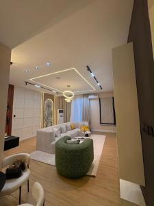 a living room with a white couch and a table at TC luxury home in Lekki