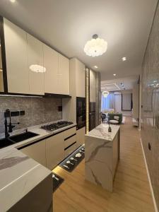 a kitchen with white cabinets and a kitchen island at TC luxury home in Lekki