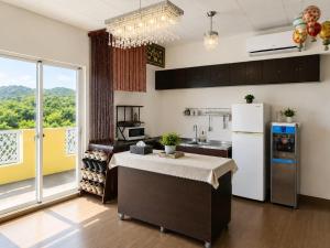 a kitchen with a refrigerator and a large window at Du Du Hao B&B in Yung-an-ts'un