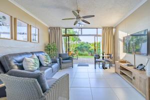 a living room with a couch and a tv at Breakers Resort 130 Umhlanga Beachfront in Durban