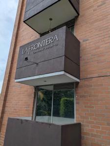 a sign on the side of a brick building at Loft Premium El Poblado in Envigado
